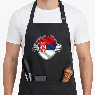 Serbian croatian girl apron - Two hands tearing grey surface to reveal red blue white Serbian flag with coat of arms — shown on a black cotton canvas apron against a white background