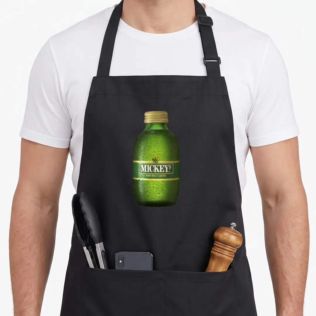 Coor bottle apron - Green bottle with MICKEY'S FINE MALT LIQUOR text, gold bee, and condensation drops — shown on a black cotton canvas apron against a white background