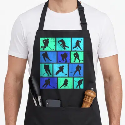 Youth hockey ice apron - Twelve grey hockey player silhouettes arranged in a grid on blue and teal square backgrounds — shown on a black cotton canvas apron against a white background