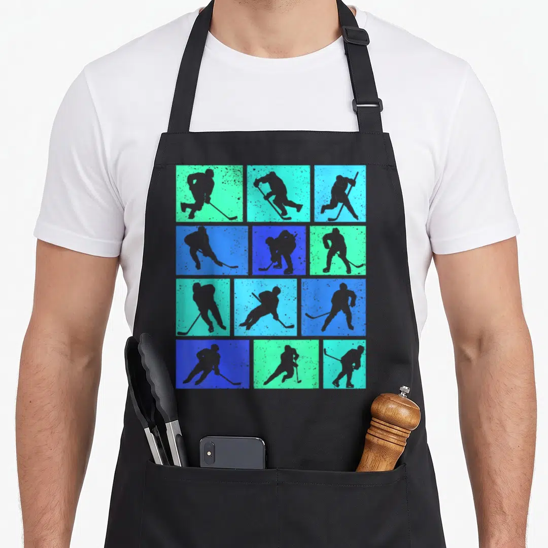 Youth hockey ice apron - Twelve grey hockey player silhouettes arranged in a grid on blue and teal square backgrounds — shown on a black cotton canvas apron against a white background