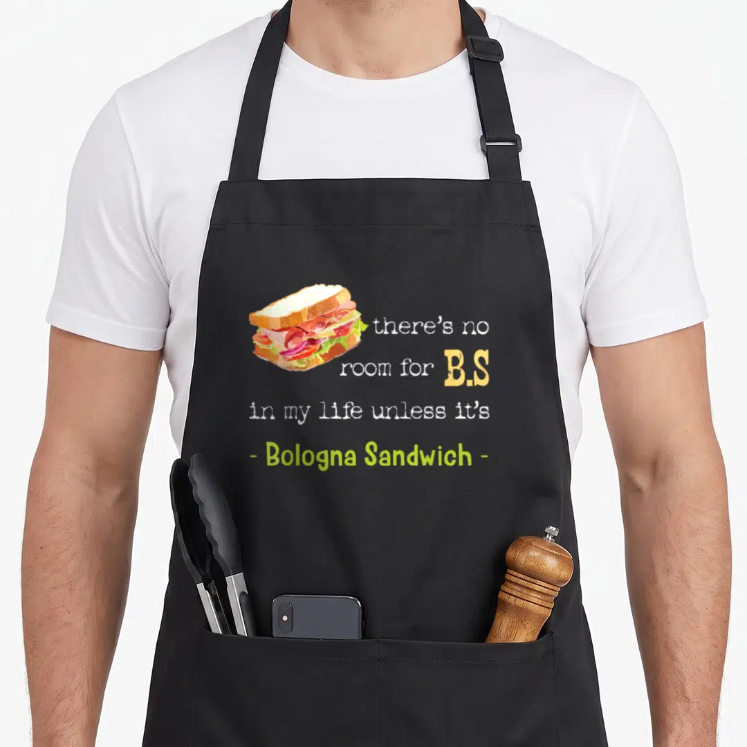 Bologna sausage apron - Cartoon sandwich with text there's no room for B.S. in my life unless it's - Bologna Sandwich - — shown on a black cotton canvas apron against a white background