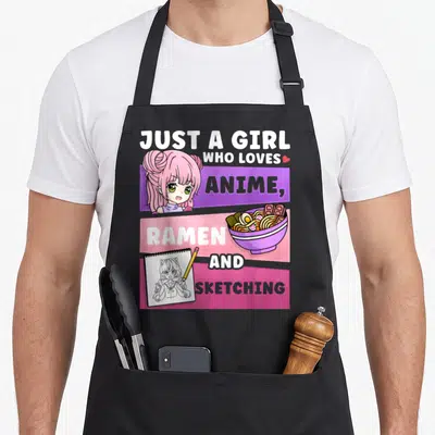 Cute ramen sketching anime apron - Anime girl, ramen bowl, and sketchbook on pink purple and yellow blocks with stacked — shown on a black cotton canvas apron against a white background