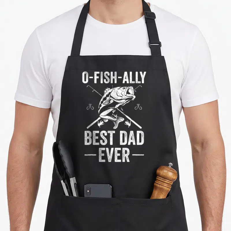 Father fishing apron - White distressed fish over crossed rods with O-FISH-ALLY BEST DAD EVER text — shown on a black cotton canvas apron against a white background