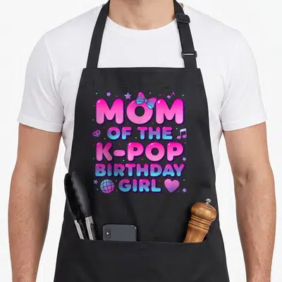 Vintage pop korean apron - Gradient text MOM OF THE K-POP BIRTHDAY GIRL with bow, stars, and disco ball — shown on a black cotton canvas apron against a white background
