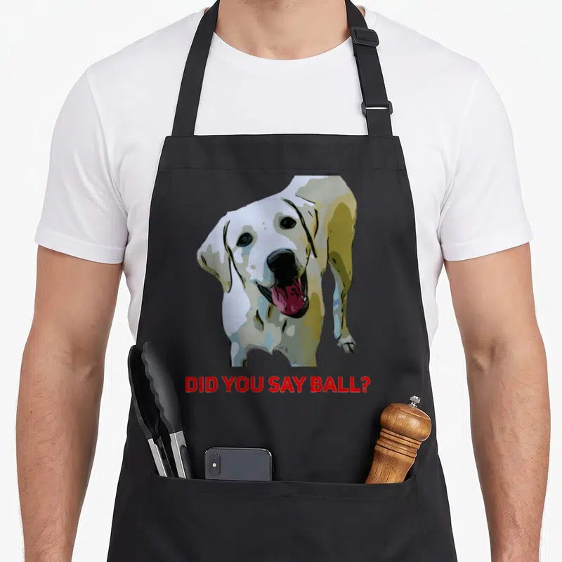 Ball lab apron - Cartoon dog head above red did you say ball text — shown on a black cotton canvas apron against a white background