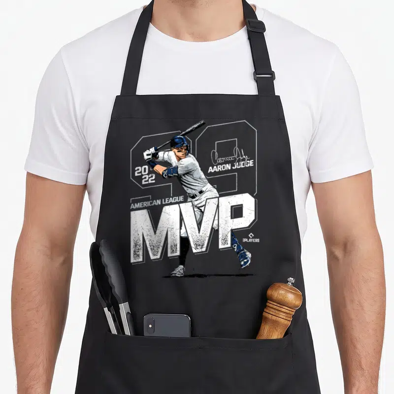 League new york apron - Aaron Judge batter print with 99 number and MVP text in white and navy — shown on a black cotton canvas apron against a white background