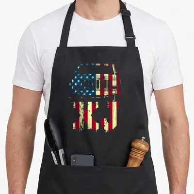 Exclusive american flag apron - Distressed red white and blue jeep front view above XJ text — shown on a black cotton canvas apron against a white background
