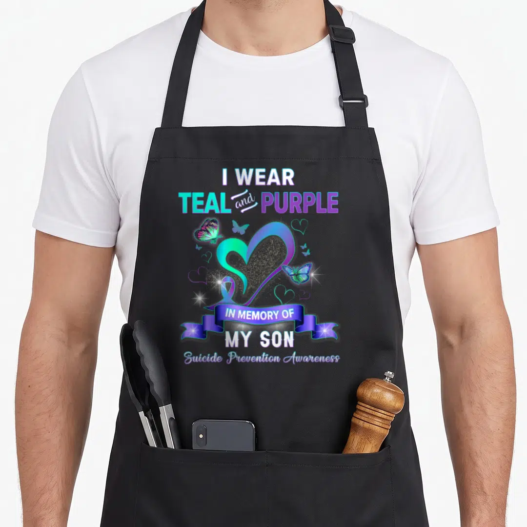 Awareness son suicide prevention apron - Heart ribbon and butterflies with I wear teal and purple in memory of my son — shown on a black cotton canvas apron against a white background