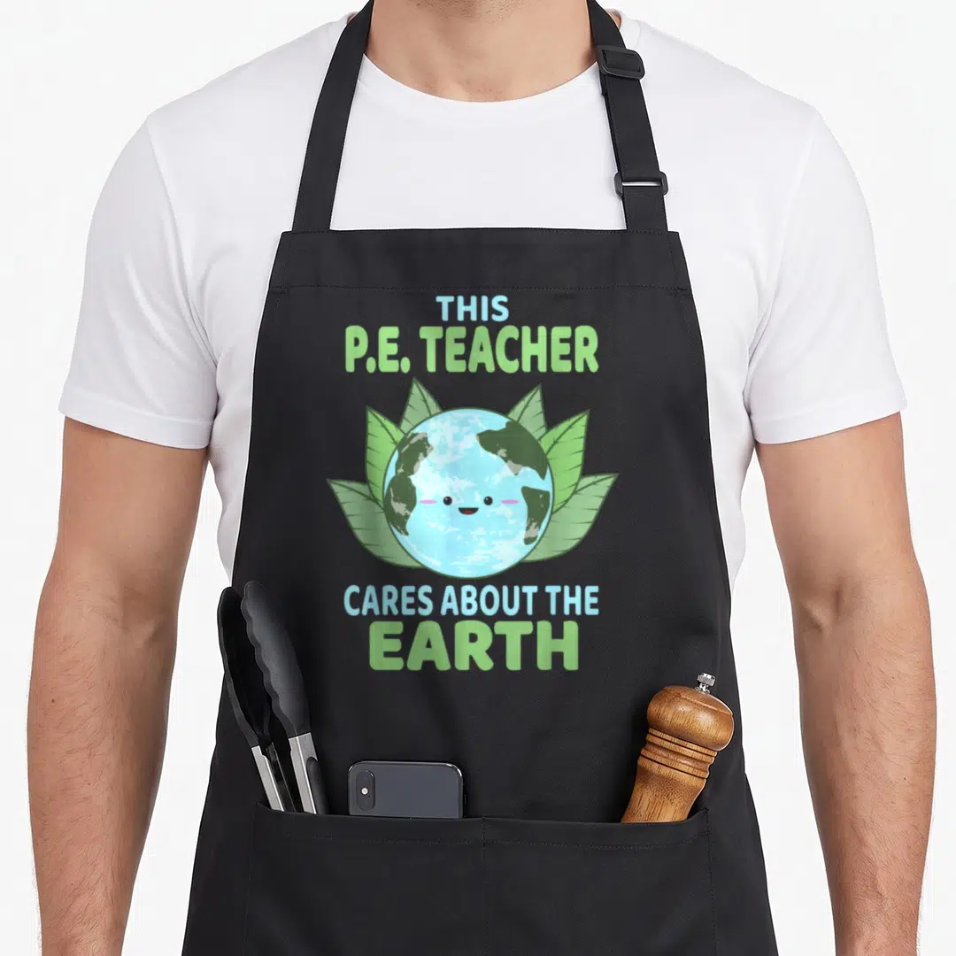 Earth classroom aprons - Cartoon Earth with leaves and text THIS P.E. TEACHER CARES ABOUT THE EARTH — shown on a black cotton canvas apron against a white background