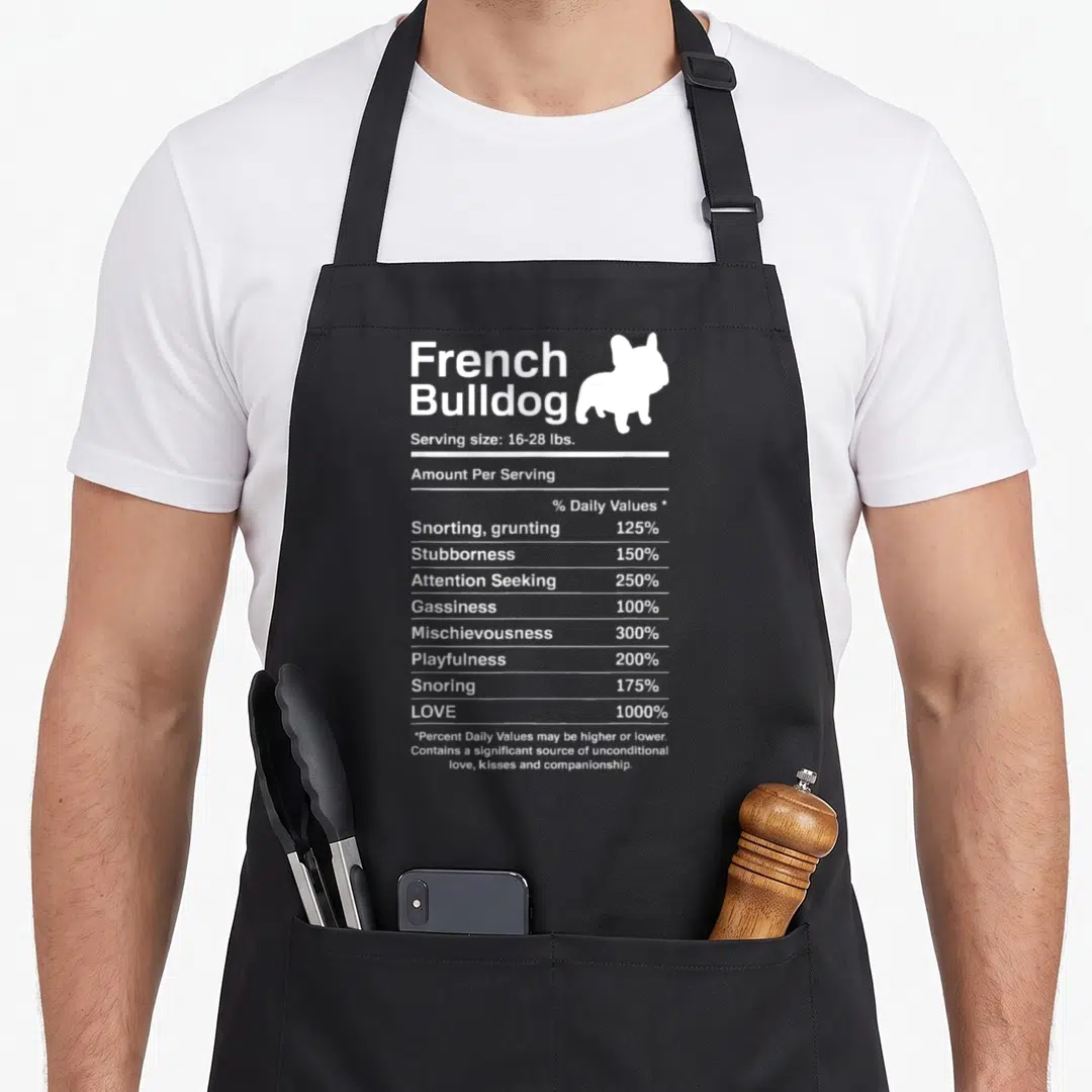Fact french bulldog apron - White nutrition label text listing French Bulldog traits next to a dog silhouette on black — shown on a black cotton canvas apron against a white background