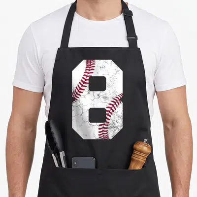 8th baseball apron - Large number 8 shaped like a baseball with red stitching on white textured background — shown on a black cotton canvas apron against a white background