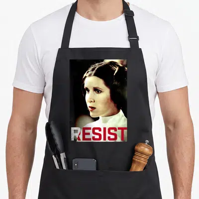 Resist princess apron - Photo of Princess Leia with red and white RESIST text across the bottom — shown on a black cotton canvas apron against a white background