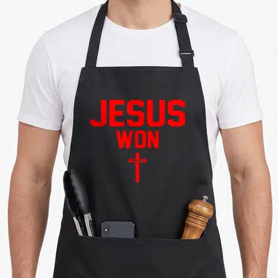 Won christian apron - Red JESUS WON text above cross with JOHN 16:33 on bar — shown on a black cotton canvas apron against a white background