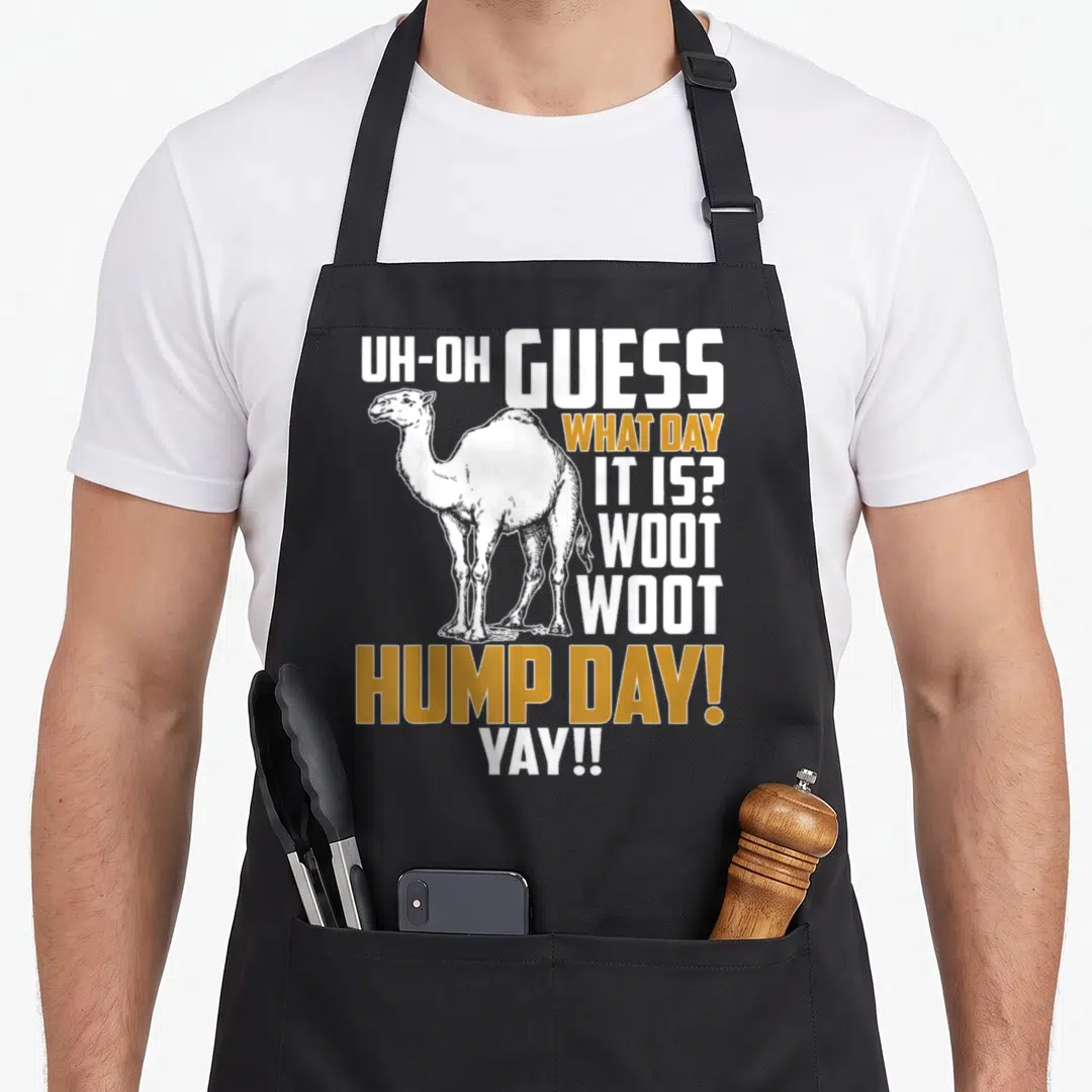 Guess hump camel apron - White line-art camel with yellow and white Guess Hump Day text — shown on a black cotton canvas apron against a white background