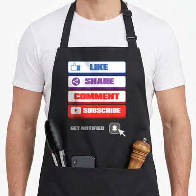 Social vlogger apron - Four stacked social media buttons in blue purple red white with like share comment subscribe — shown on a black cotton canvas apron against a white background