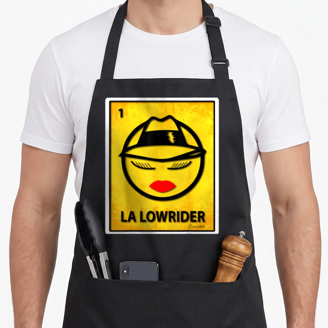 Funny lowrider apron - Stylized face with hat and red lips on yellow background with LA Lowrider text — shown on a black cotton canvas apron against a white background