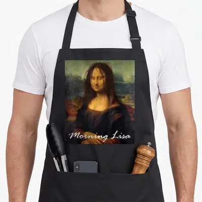 Mona office apron - Morning Lisa text over messy-haired woman in landscape background — shown on a black cotton canvas apron against a white background