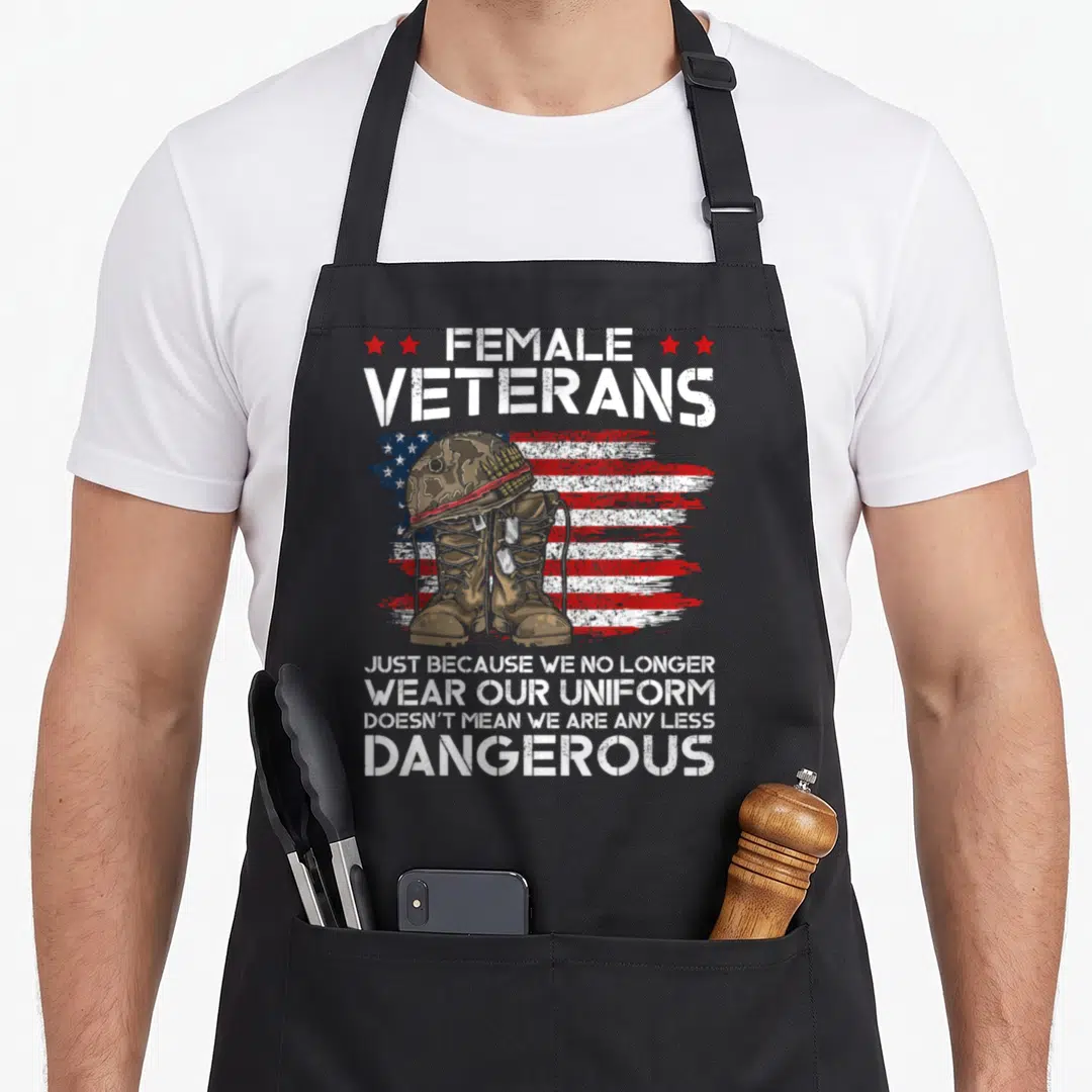 Veteran grandma apron - Helmet and boots on distressed flag with Female Veterans text — shown on a black cotton canvas apron against a white background