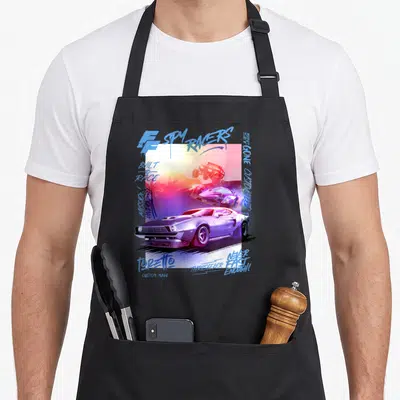 Fast racer girl apron - Three retro cars in purple and orange with SPY RACERS and BUILT TO RACE graffiti text — shown on a black cotton canvas apron against a white background