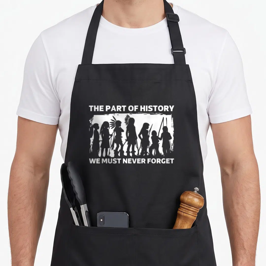 History parts of an apron - White silhouettes of Native Americans with text The Part of History We Must Never Forget — shown on a black cotton canvas apron against a white background