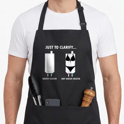 Water joke apron - Two white water heaters, one wearing a black bikini, with clarifying text labels — shown on a black cotton canvas apron against a white background