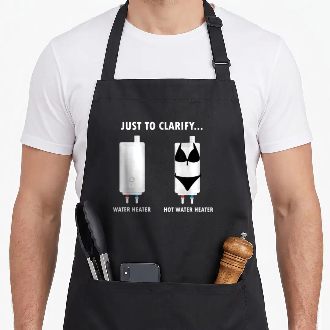 Water joke apron - Two white water heaters, one wearing a black bikini, with clarifying text labels — shown on a black cotton canvas apron against a white background