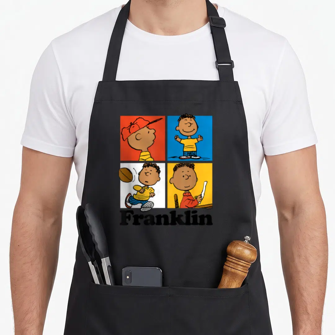Franklin blue apron - Four colored squares with character poses above bold Franklin text — shown on a black cotton canvas apron against a white background