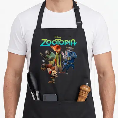 Character aprons for men - ZOOTOPIA logo above Nick Wilde and animal friends in orange blue green grey photo style — shown on a black cotton canvas apron against a white background