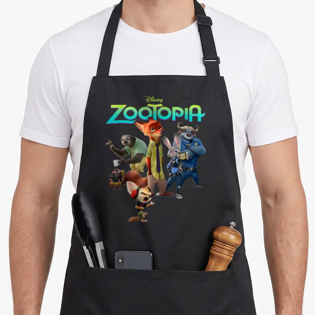 Character aprons for men - ZOOTOPIA logo above Nick Wilde and animal friends in orange blue green grey photo style — shown on a black cotton canvas apron against a white background