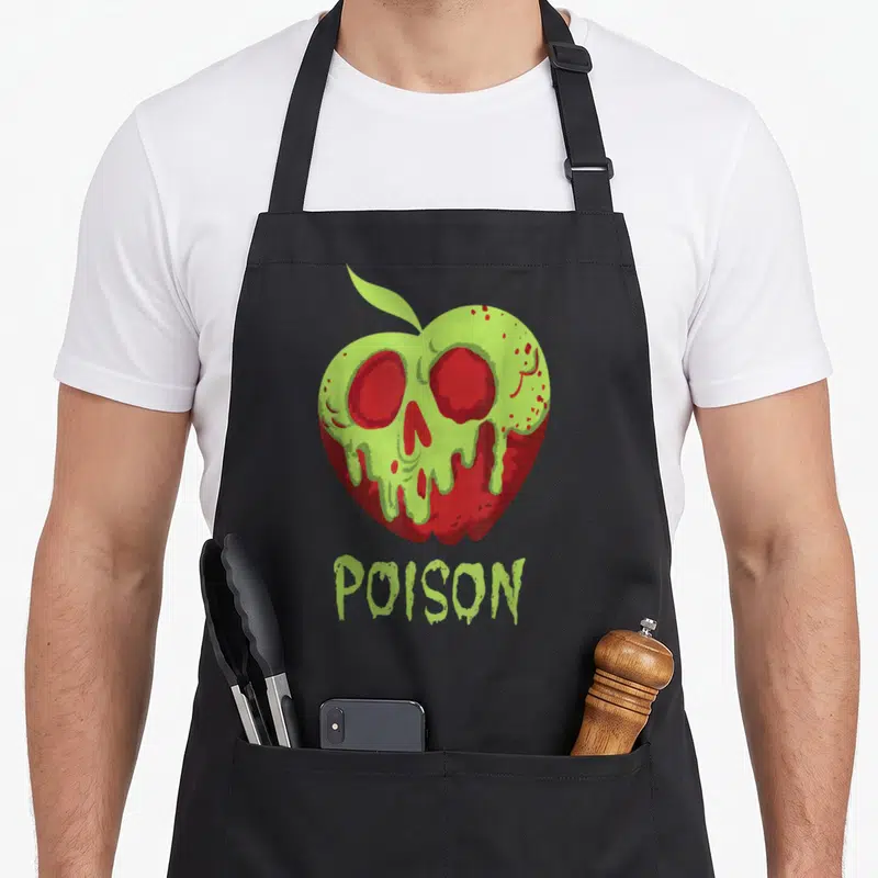 Wreck apple apron - Red apple with melting lime green skull and POISON text below — shown on a black cotton canvas apron against a white background