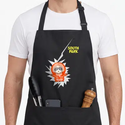 Lightening south apron - Cartoon character in orange suit inside white burst with yellow SOUTH PARK text and lightning — shown on a black cotton canvas apron against a white background