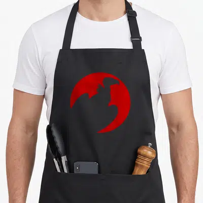 Vulture animal apron - Grey eagle silhouette inside a red circle on a black apron — shown on a black cotton canvas apron against a white background