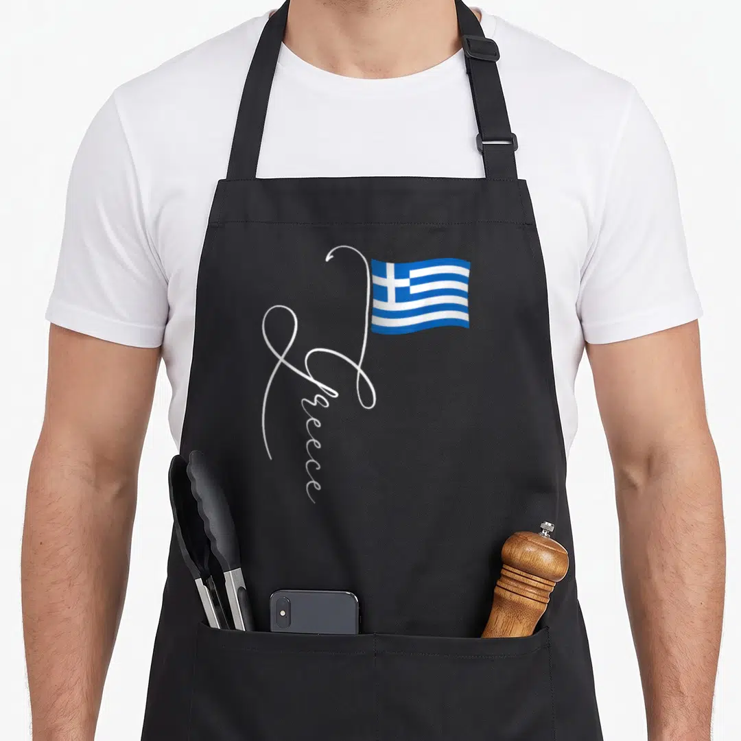 Family greek aprons - White script Greece forming a flagpole for a waving blue and white flag — shown on a black cotton canvas apron against a white background