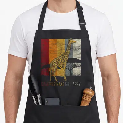 Zoo giraffe apron - Retro giraffe and trees on red orange grey stripes with happy text — shown on a black cotton canvas apron against a white background