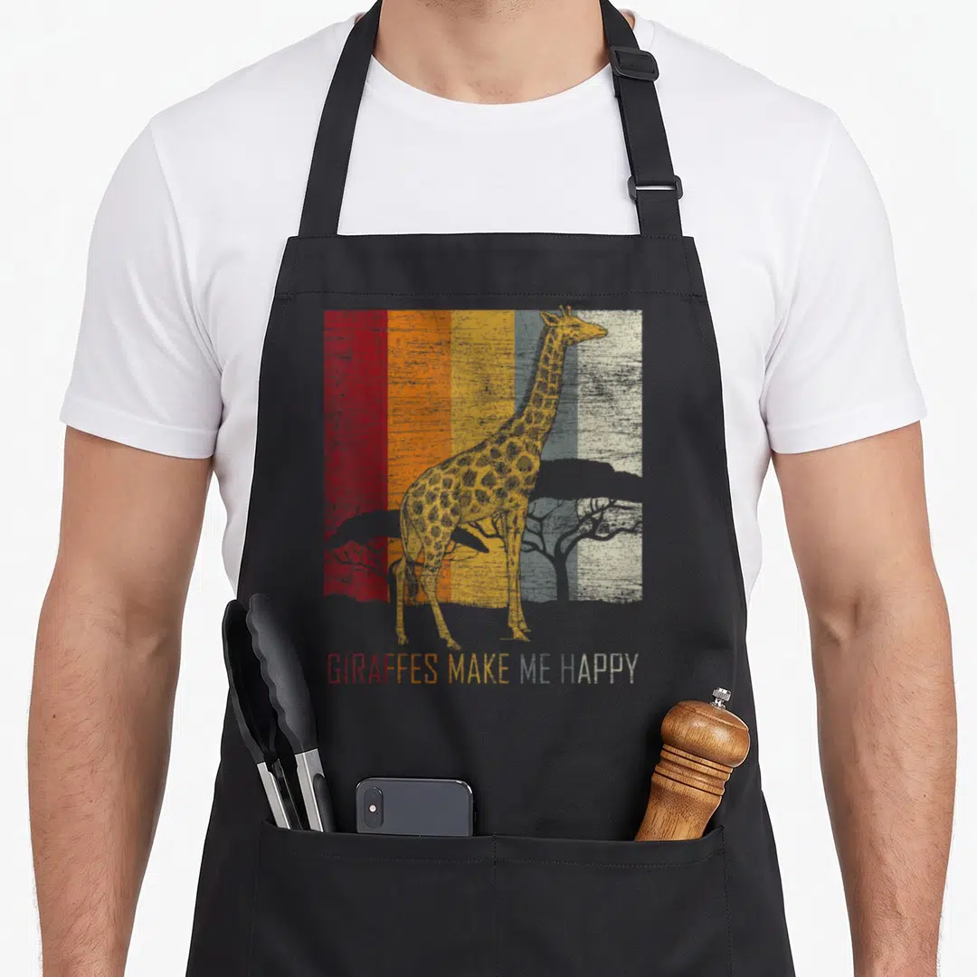 Zoo giraffe apron - Retro giraffe and trees on red orange grey stripes with happy text — shown on a black cotton canvas apron against a white background