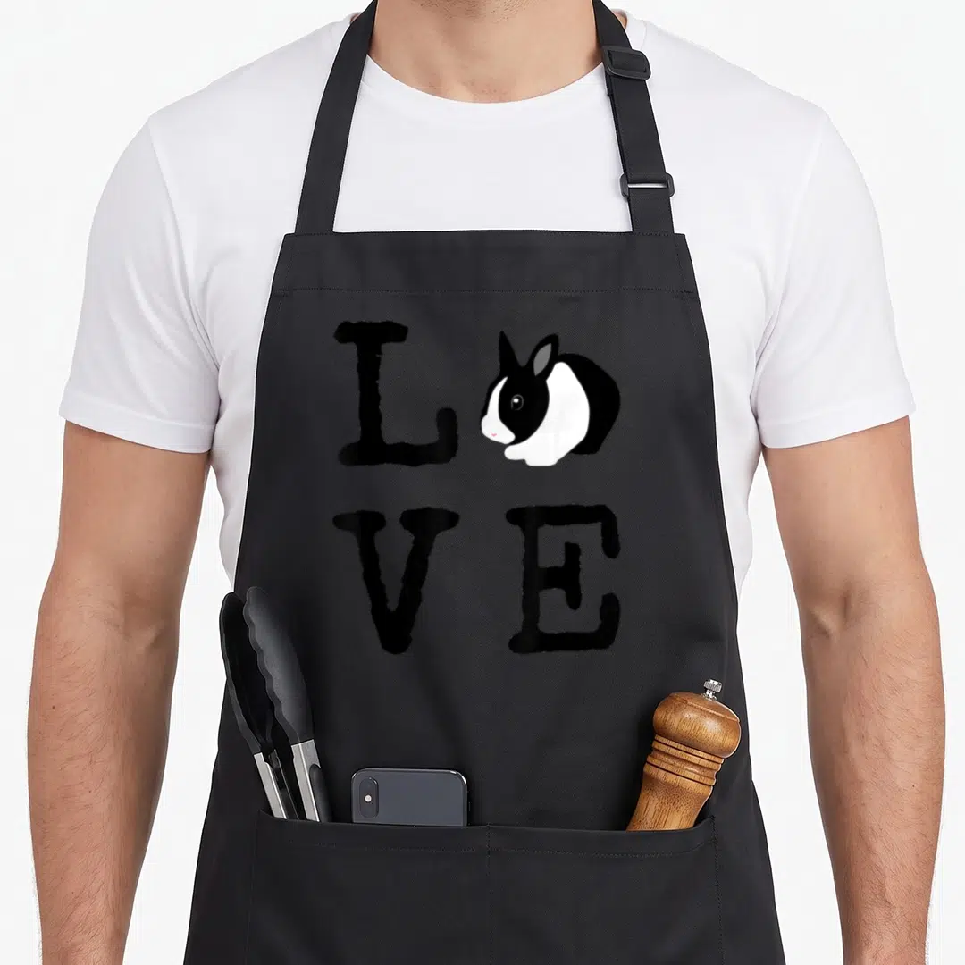 Bunny dutch apron - Black and white rabbit replacing O in LOVE letters arranged in 2x2 grid — shown on a black cotton canvas apron against a white background