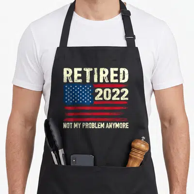 Problem american flag apron - Distressed USA flag with 2022 and retired text on black background — shown on a black cotton canvas apron against a white background