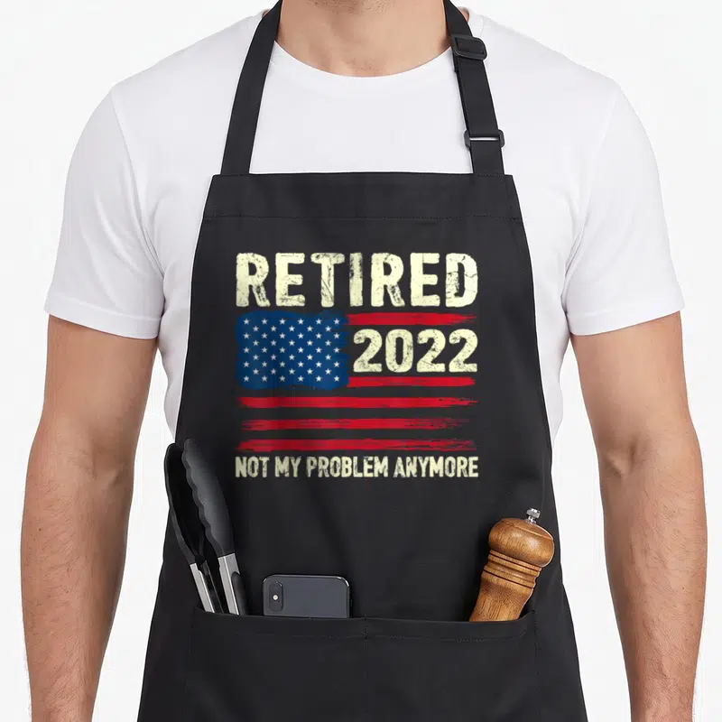 Problem american flag apron - Distressed USA flag with 2022 and retired text on black background — shown on a black cotton canvas apron against a white background