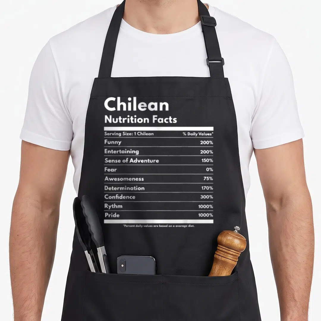 Chilean nutrition pride apron - White nutrition facts label text listing 1000% pride and 0% fear on a dark background — shown on a black cotton canvas apron against a white background