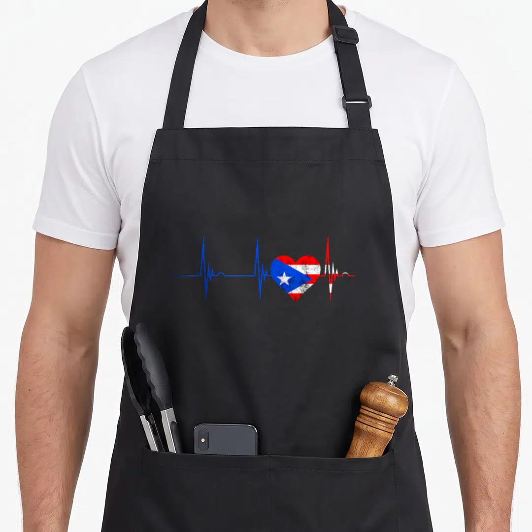 Rico puerto rican apron - Heartbeat line with red white and blue flag heart in minimalist style — shown on a black cotton canvas apron against a white background