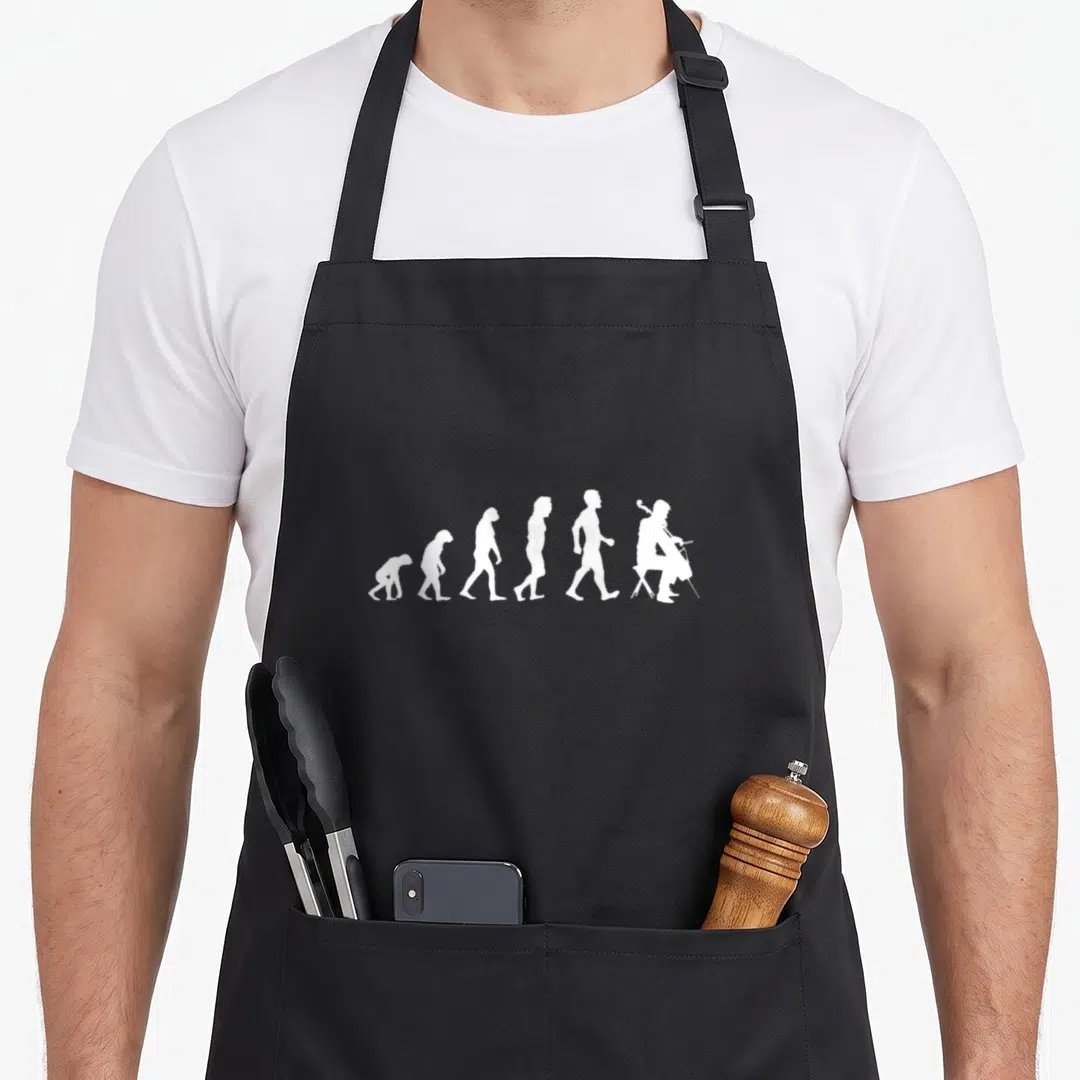 Evolution cello apron - Six white silhouettes evolving from ape to seated cellist on grey background — shown on a black cotton canvas apron against a white background