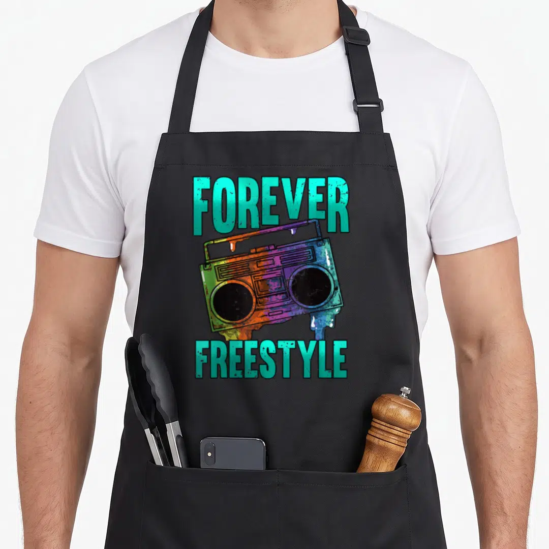Freestyle hip apron - Rainbow boombox with teal drips and FOREVER FREESTYLE text on black fabric — shown on a black cotton canvas apron against a white background