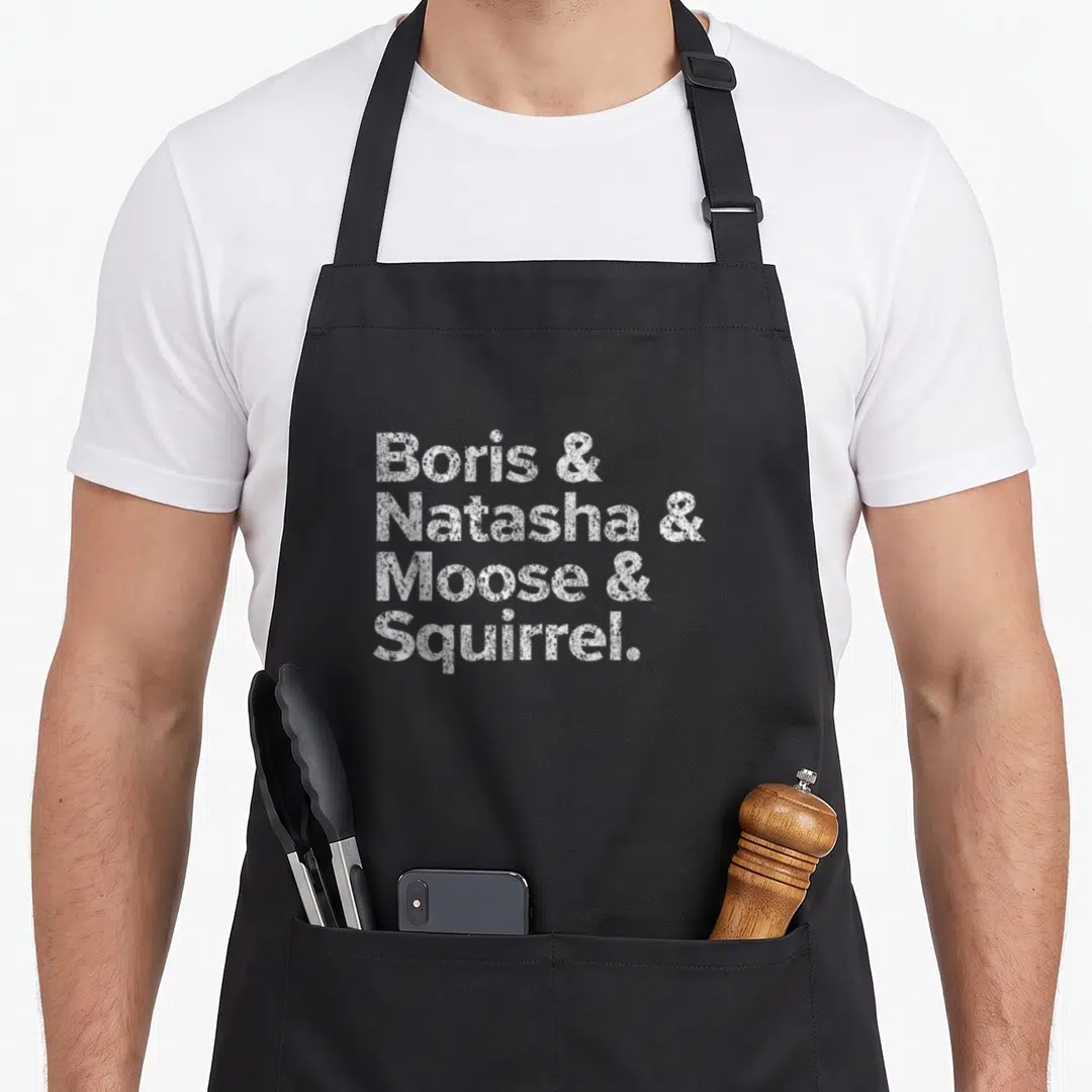 Boris squirrel aprons - White stacked text Boris Natasha Moose Squirrel distressed font on grey background — shown on a black cotton canvas apron against a white background