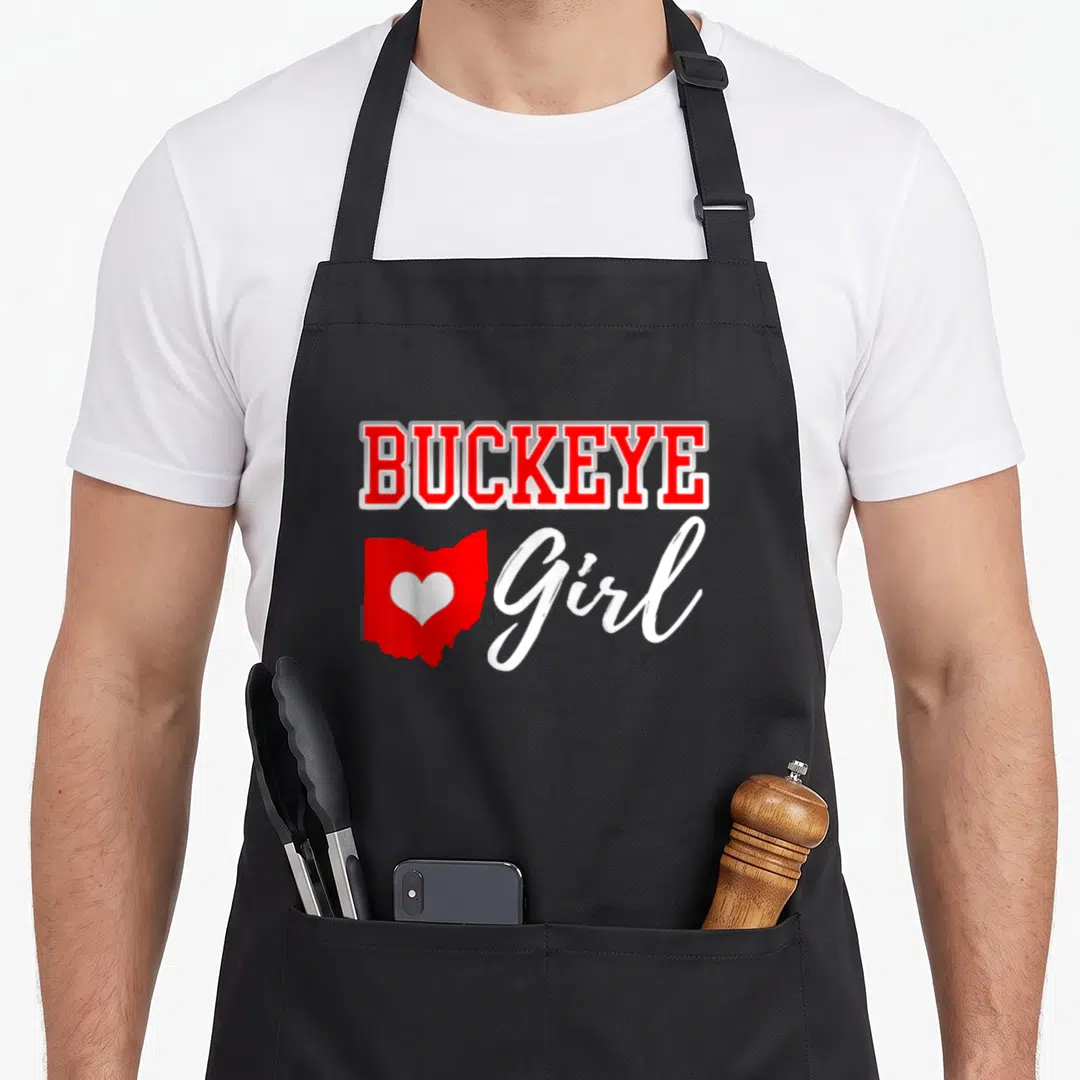 Buckeye cutecomfy apron - Red BUCKEYE text above red Ohio map with white heart and white Girl script — shown on a black cotton canvas apron against a white background