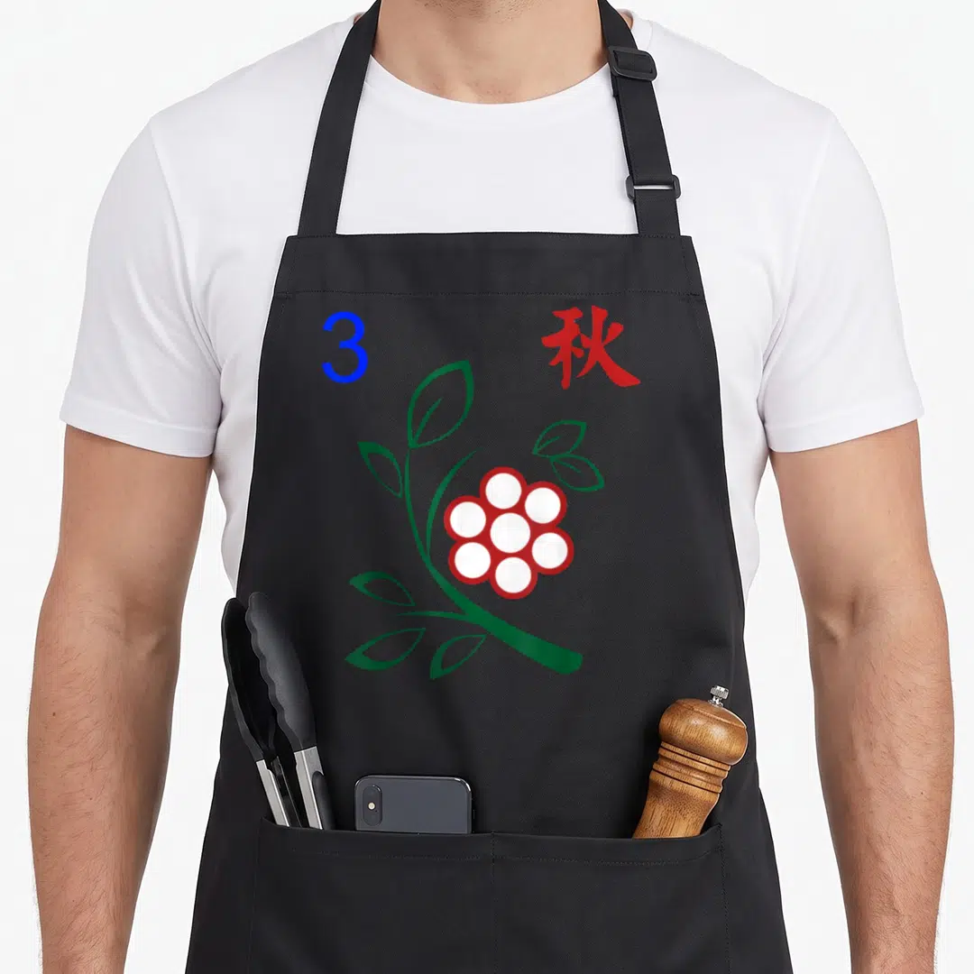 Blue mahjong apron - Blue number 3 and red kanji beside green stem with white flower and red border — shown on a black cotton canvas apron against a white background