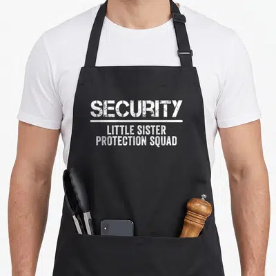 Protection birthday apron - White distressed text reading Security Little Sister Protection Squad separated — shown on a black cotton canvas apron against a white background