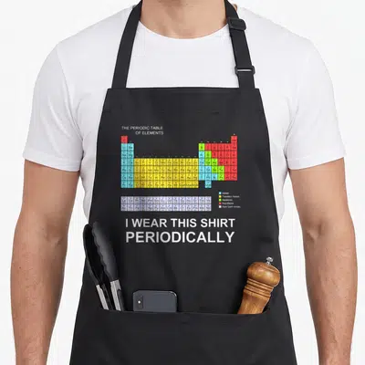 Periodically science apron - Colorful periodic table chart with white pun text I wear this shirt periodically below — shown on a black cotton canvas apron against a white background