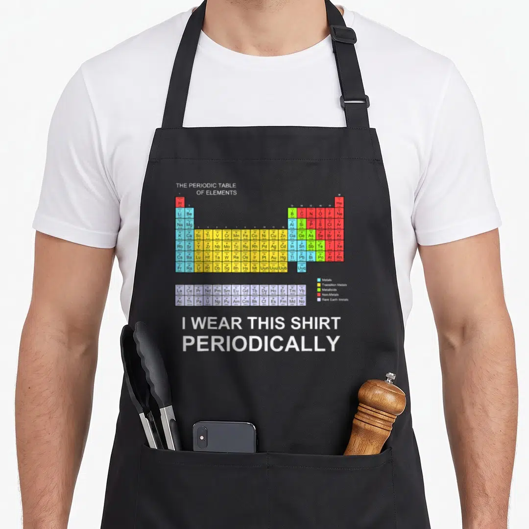 Periodically science apron - Colorful periodic table chart with white pun text I wear this shirt periodically below — shown on a black cotton canvas apron against a white background