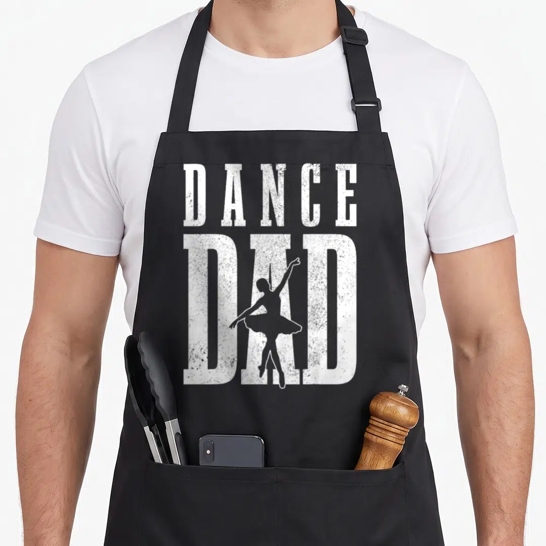 Ballet father day apron - DANCE DAD text with white ballerina silhouette in distressed style — shown on a black cotton canvas apron against a white background