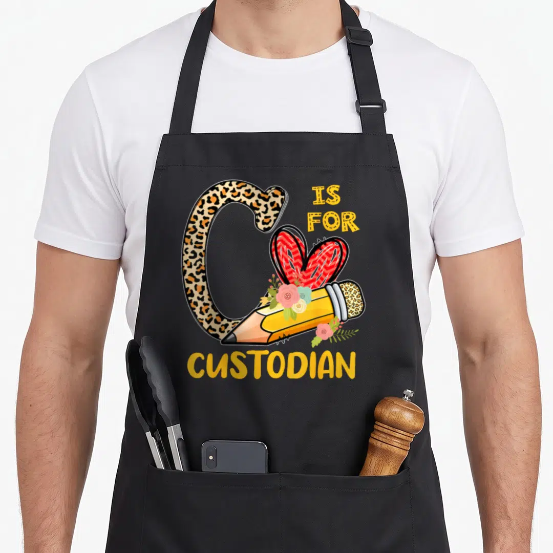 Custodian leopard apron - Leopard print letter C with pencil flowers and red heart reading IS FOR CUSTODIAN — shown on a black cotton canvas apron against a white background